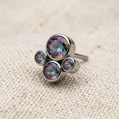 Silver ring with multicolored gemstones on a textured beige background