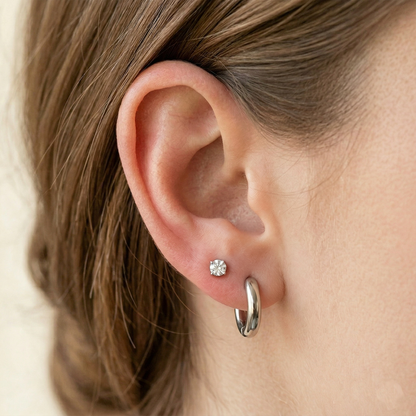 Surgical steel 3mm plain huggie hoop earrings on ear with double lobe piercings
