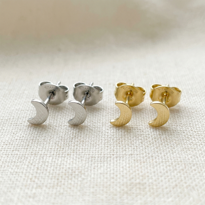 Silver and gold titanium crescent moon stud earrings side by side comparison