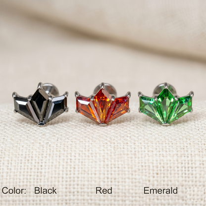 Three gemstone earrings in black, red, and green on a beige background.