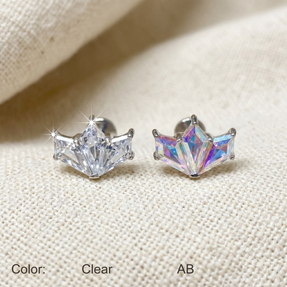 Pair of star-shaped earrings on a textured fabric background
