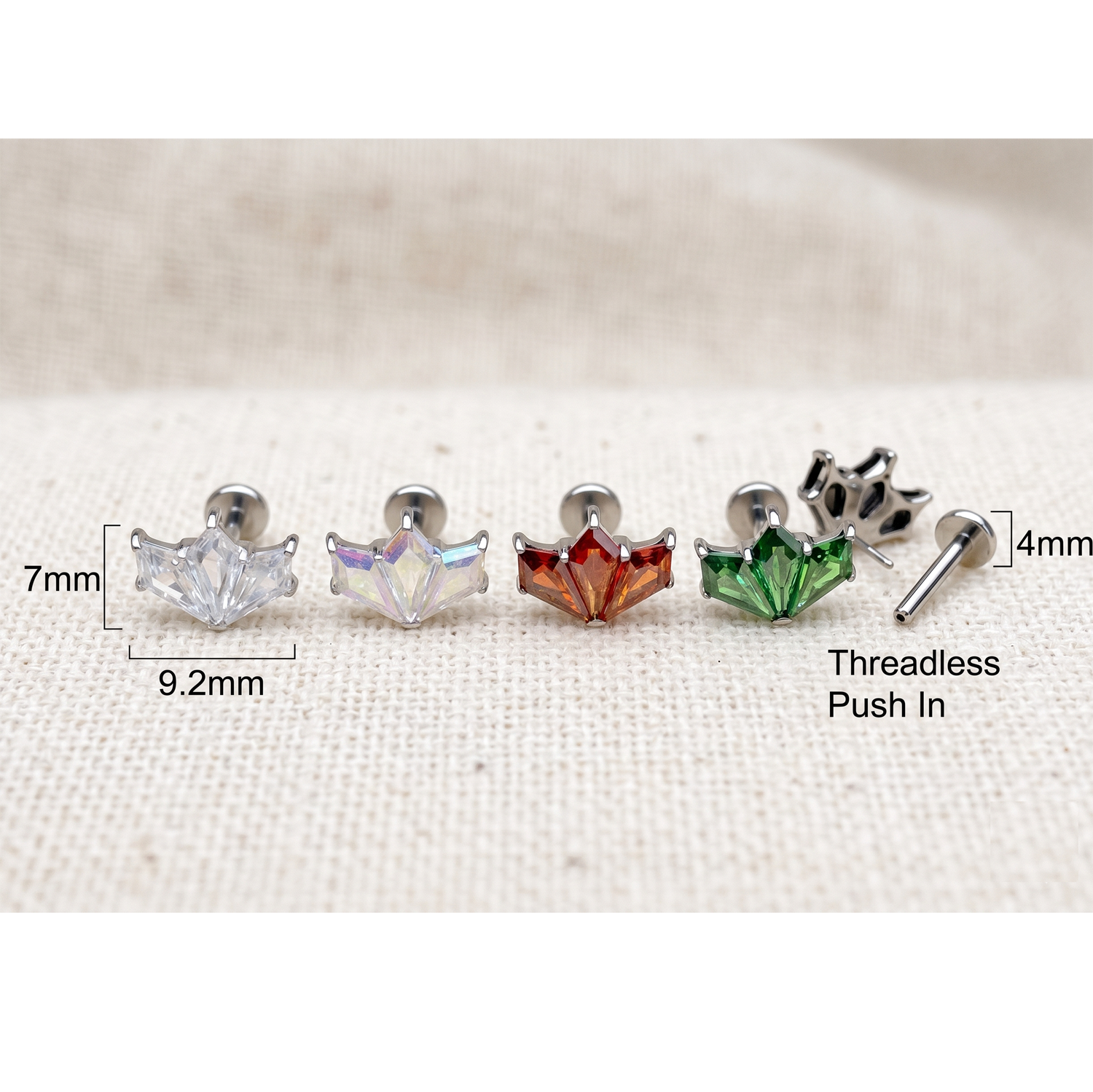 Set of five earrings with measurements on a white fabric background