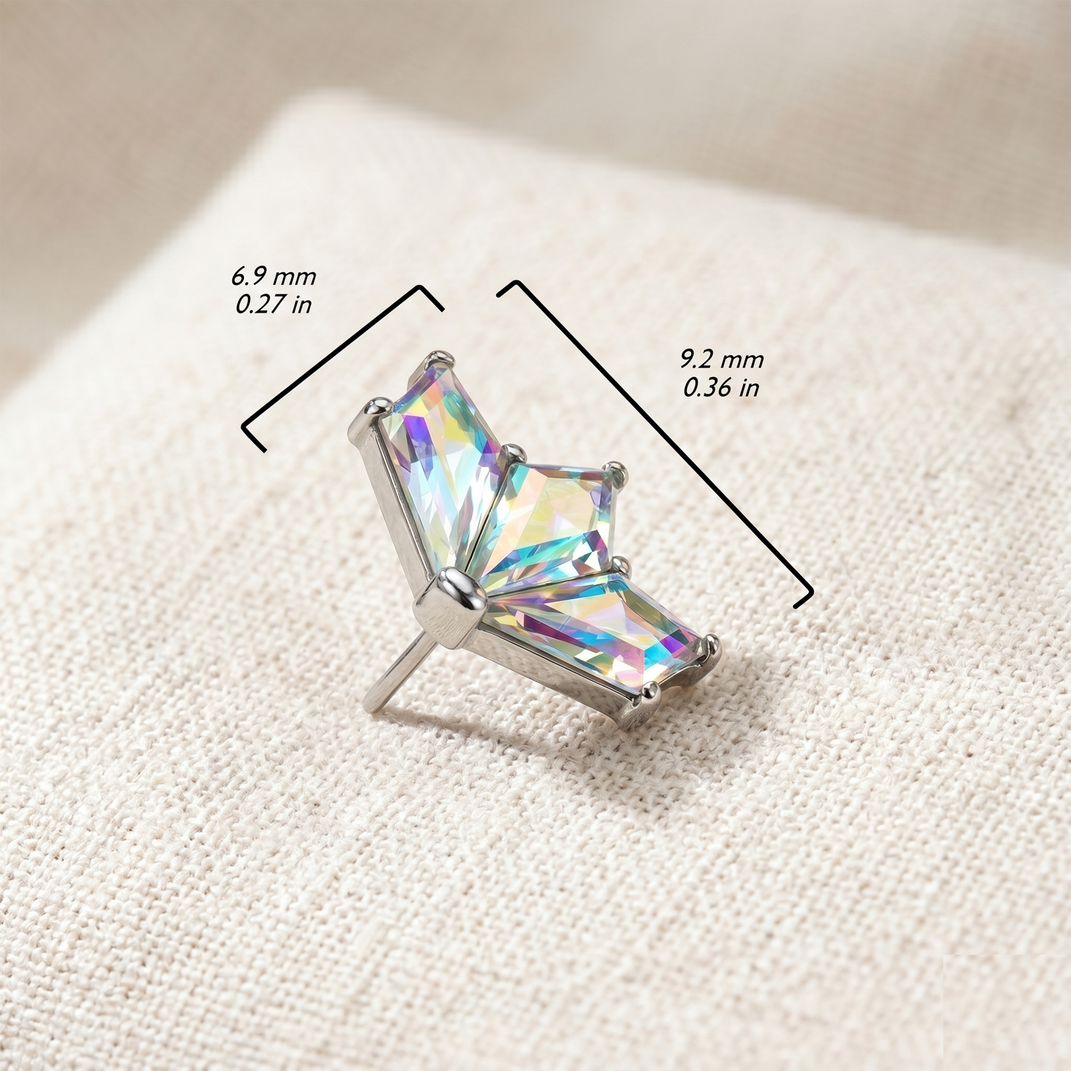 Crystal earring on a textured surface with measurements indicated