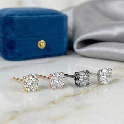 Gold titanium clear CZ threadless stud lifestyle photo on blue velvet
