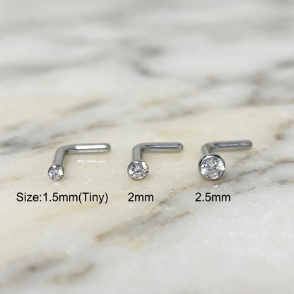 Titanium CZ L-bend nose studs size comparison 1.5mm 2mm 2.5mm on marble