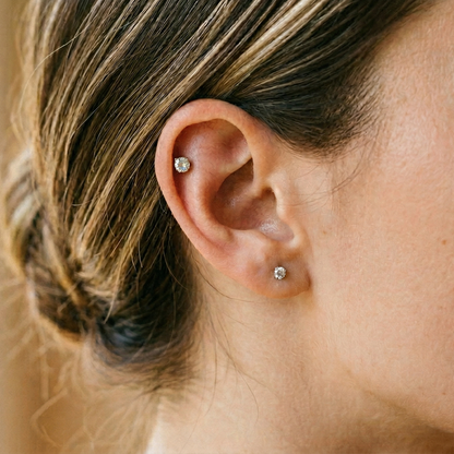 Titanium CZ prong stud shown on helix cartilage piercing
