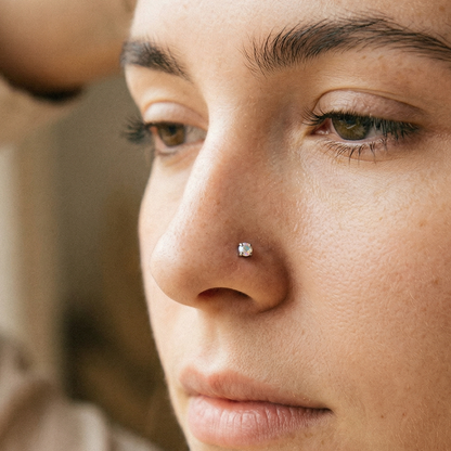 Titanium CZ prong stud shown on nostril piercing

