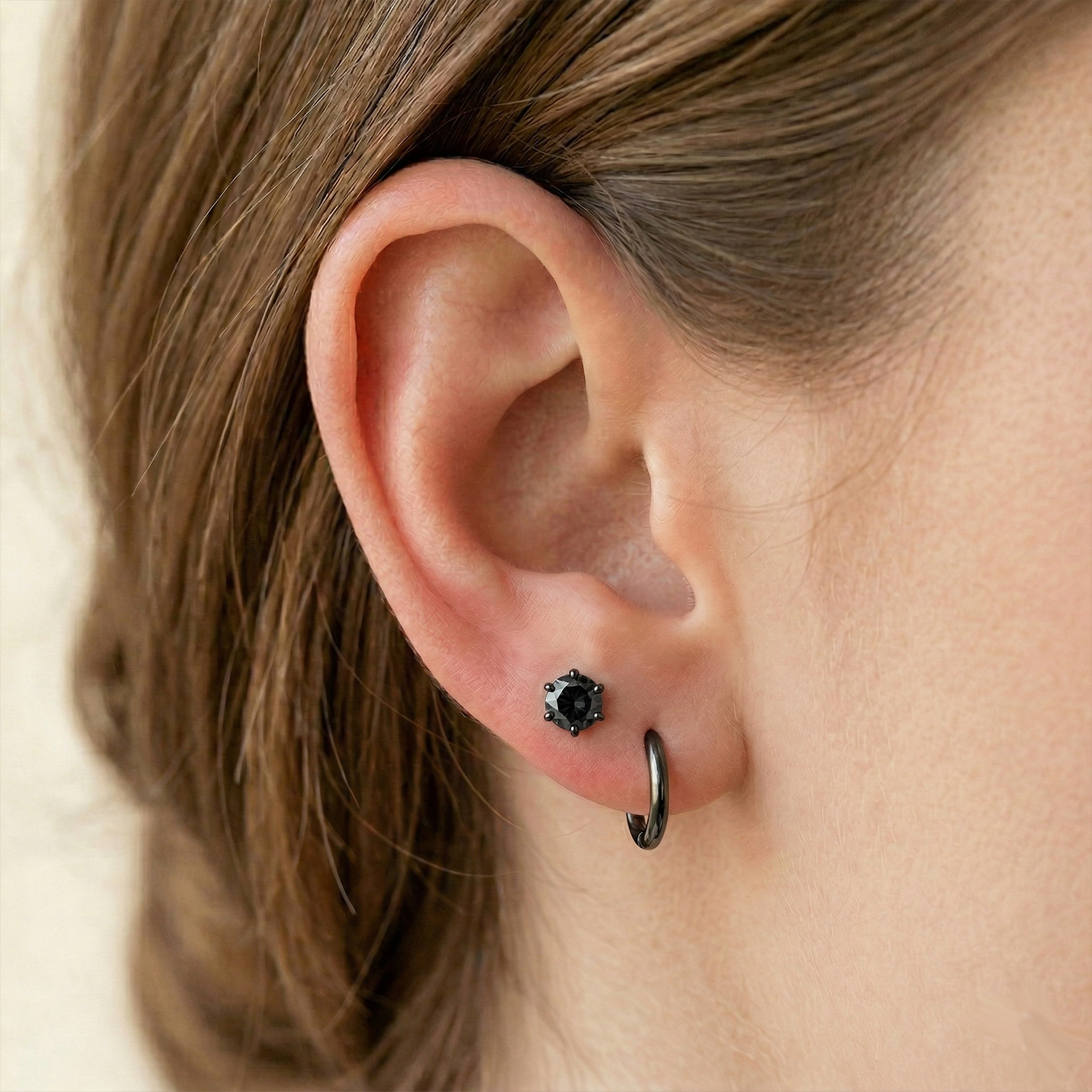 Black CZ surgical steel stud earrings on ear with double lobe piercings