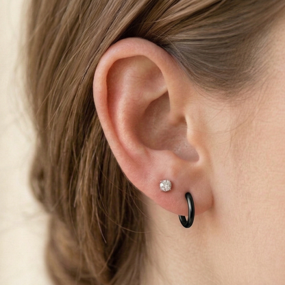 Surgical steel 2mm plain huggie hoop earrings close-up on ear