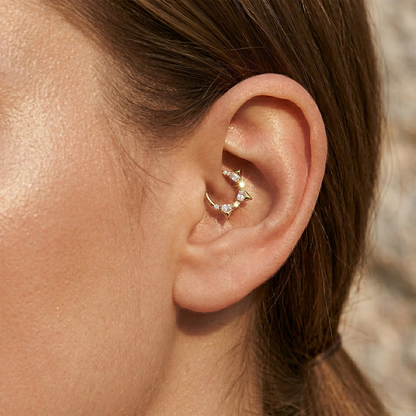 Silver titanium CZ spike hinged hoop shown on ear with helix piercing