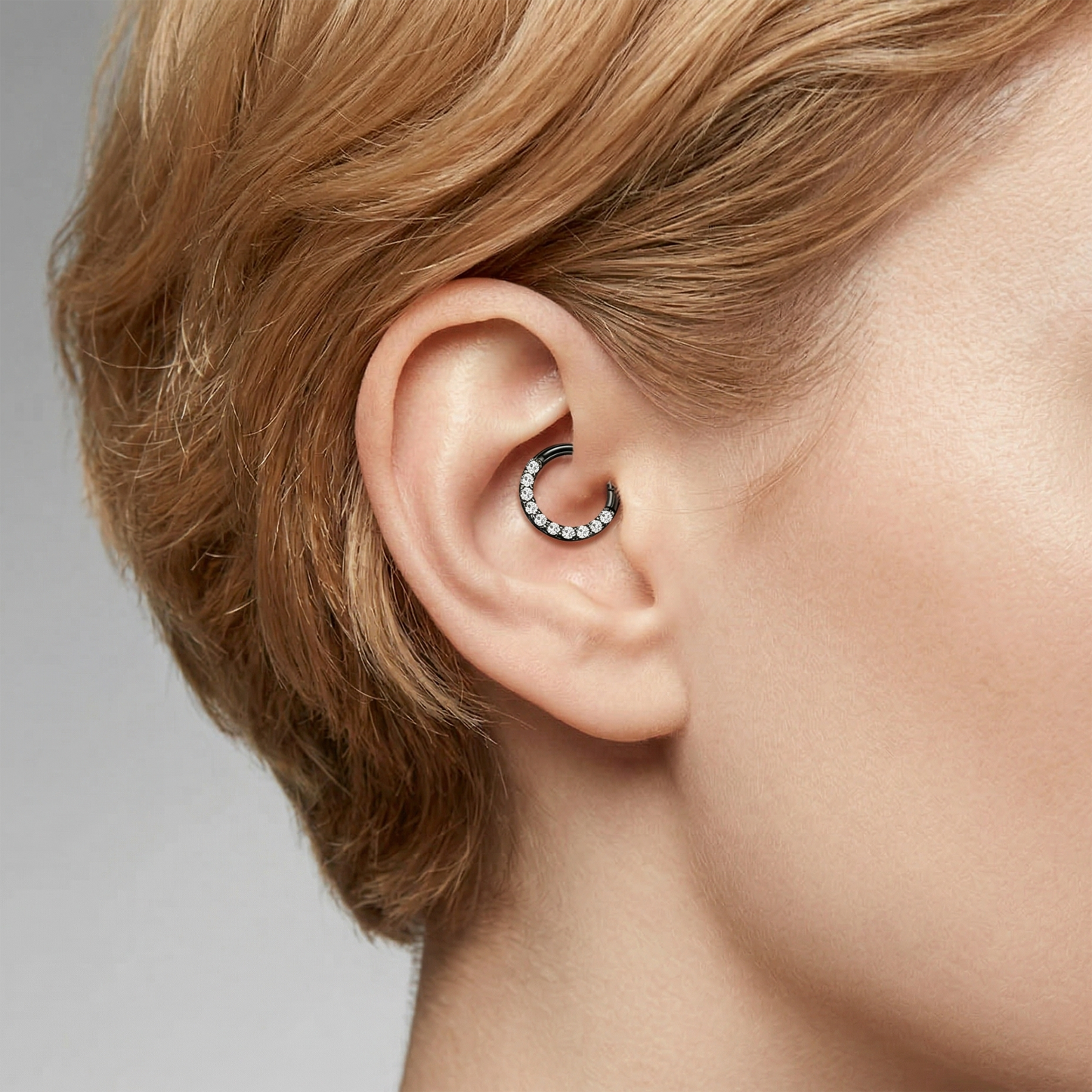 Titanium CZ front hinged hoop shown on ear with helix piercing