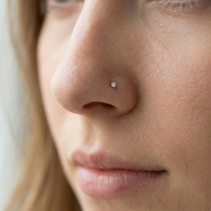 Clear CZ nose stud shown on nostril piercing