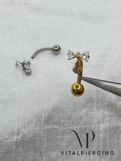 Titanium belly button ring with bowtie CZ dangle 14G curved barbell