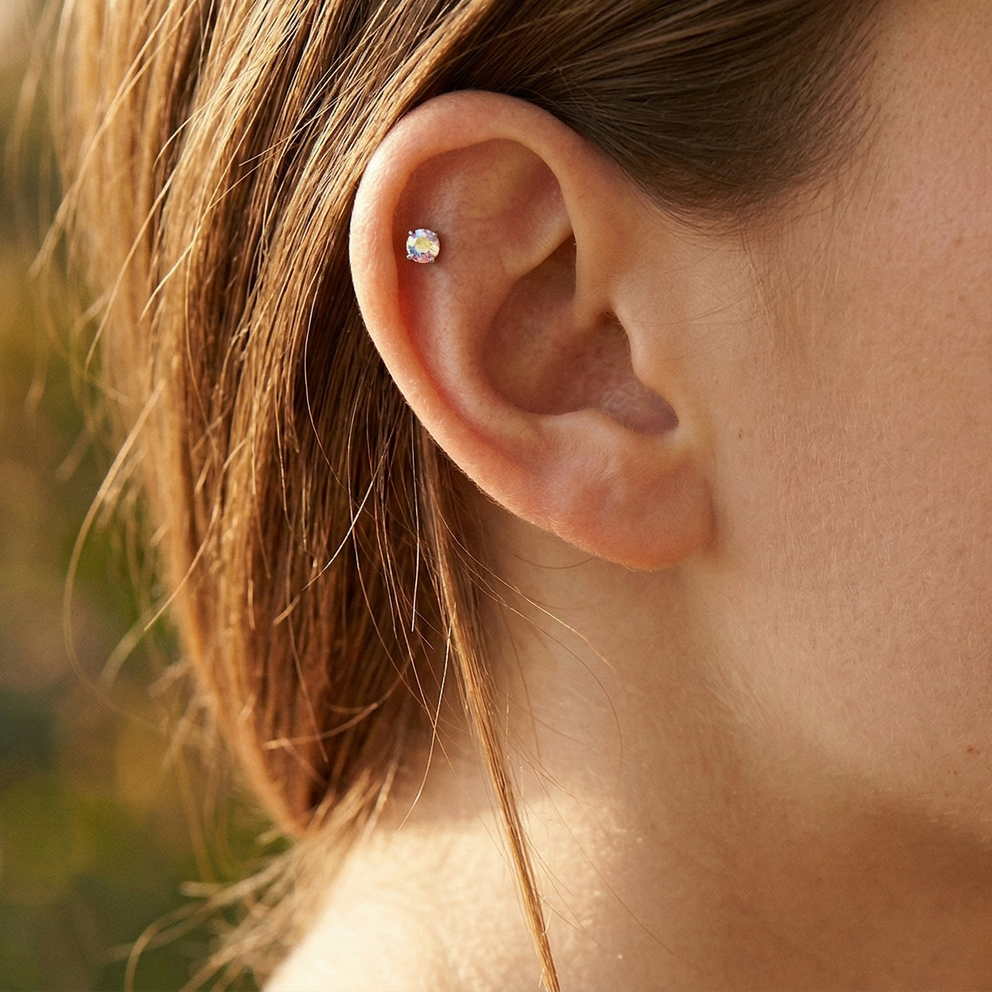 Titanium CZ prong stud shown on ear helix piercing
