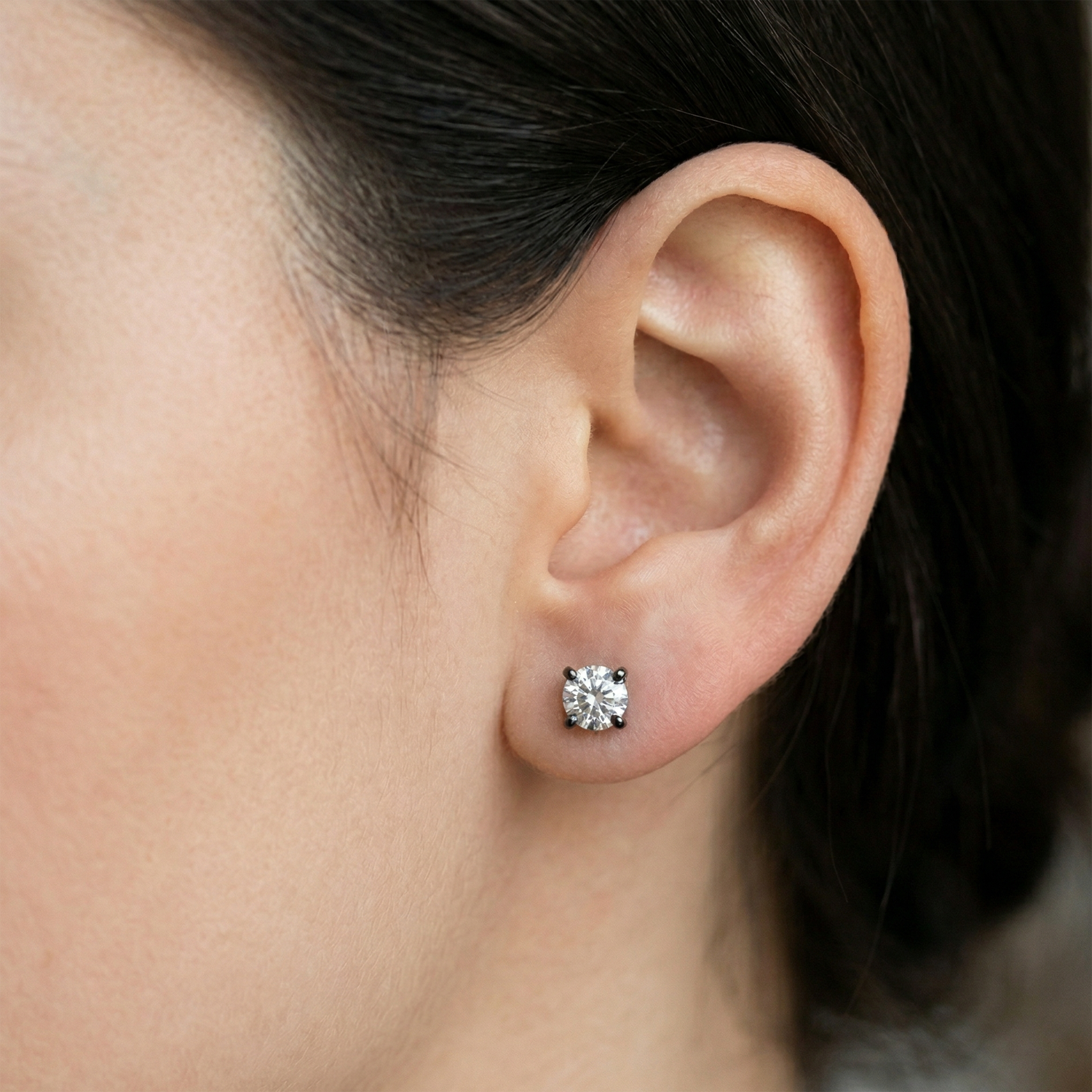 Black titanium clear CZ stud earring shown on ear with lobe piercing
